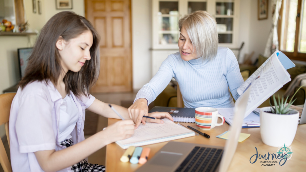 Teen working on physics homework with mom’s guidance at the kitchen table