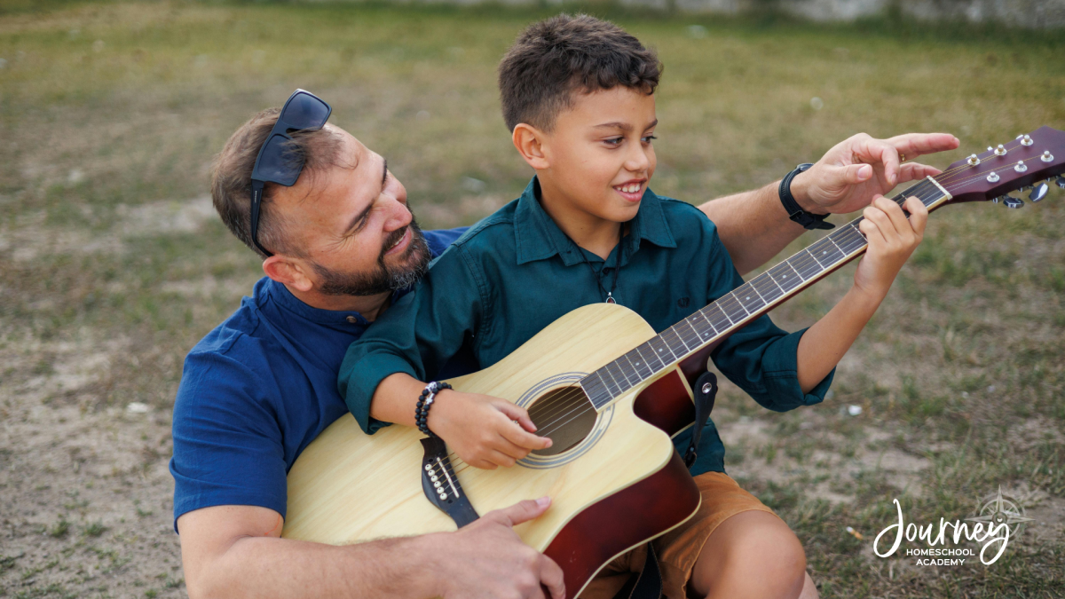 Father teaching son guitar and exploring music and sound – Journey Homeschool Academy homeschool science