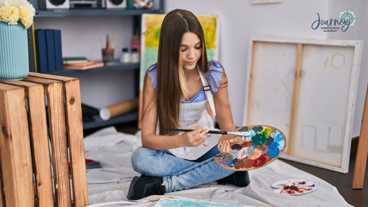 Teen girl sitting on the floor painting with a palette of mixed colors, homeschool art activity illustration for Journey Homeschool Academy.