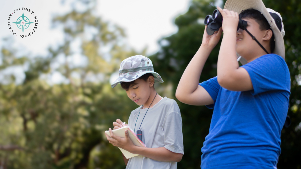 Two children with binoculars and a notebook observing birds outdoors as part of a bird nesting homeschool nature study from Journey Homeschool Academy